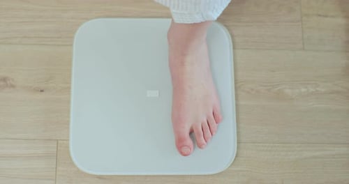 Top Shot Woman Feet Standing Weighing Scales Concept of Dieting Loosing Weight and Healthy Lifestyle