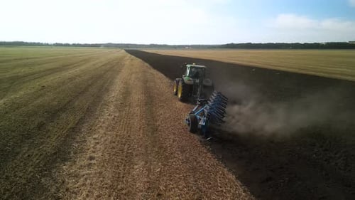 Tractors plowing the field in Ukraine