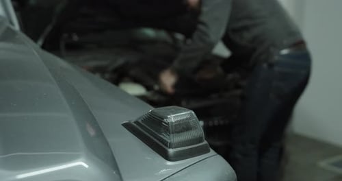 Frustrated Man Checking Broken Car Engine