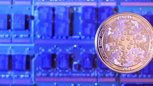 A close tracking shot of Cardano ADA crypto currency coin hovering over a mining rig of computer chi