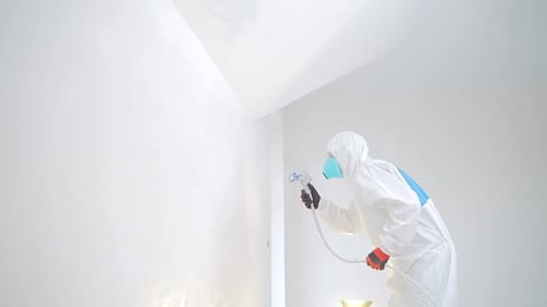 Protective Gear Painting Wall with Sprayer