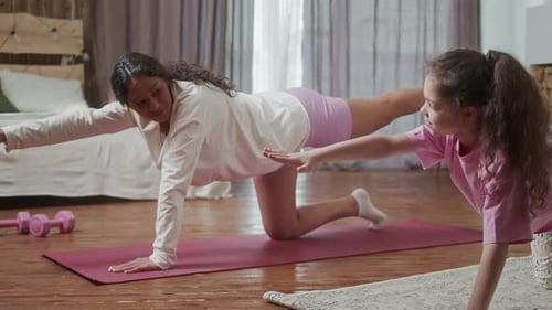 Woman and Child Exercising Together on Yoga Mats