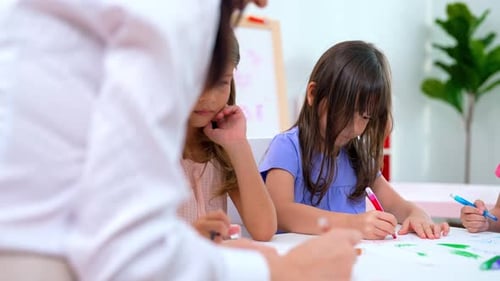 Children Drawing Together at Table with Colored Markers