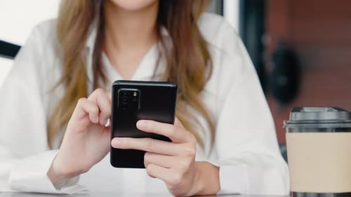 Happy female lifestyle sitting in cafe near window she cellphone on mobile phone