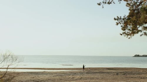 Mother and Child Walking on the Beach with the Horizon Far Away A Peaceful and Picturesque Beach