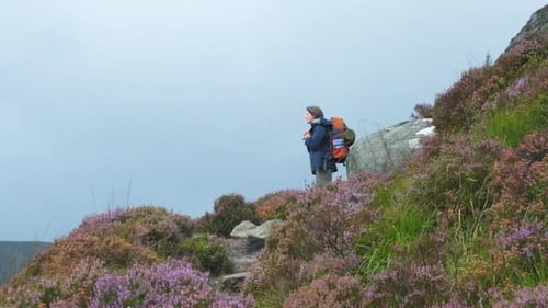 Female climber, remote summit solitude, backpacker gear