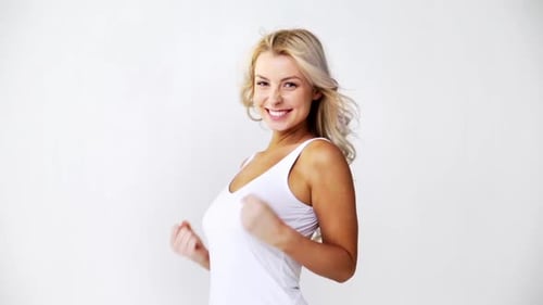 Smiling blonde woman in white shirt looking at camera