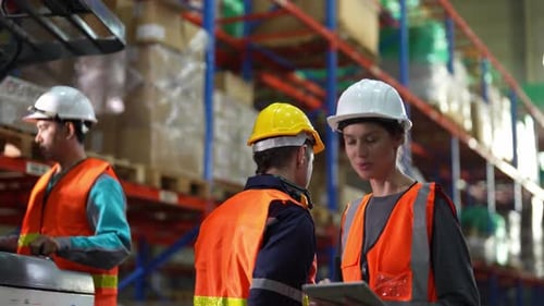 Warehouse Industrial and Logistics Companies. Dispatcher in uniform making inventory in storehouse.