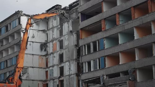 Destruction excavator house demolishing. Demolition building by machine.