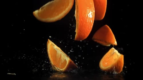 Sliced Orange Slices Fall on the Table Filmed on a Highspeed Camera at 1000 Fps