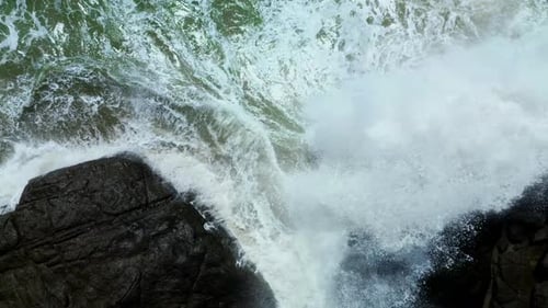 Aerial Top View of Waves Crashing on Rocks in a Blue Ocean Sea Waves on a Beautiful Beach Aerial