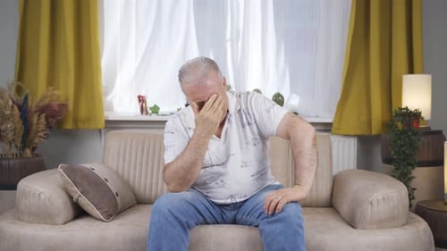 Sad old man is crying.