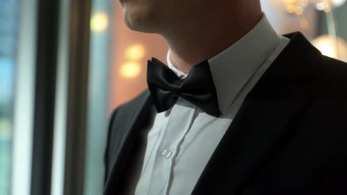 Man in Tuxedo Adjusting Bow Tie, Formal Wear