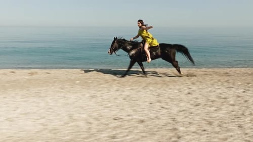 Woman Galloping on a Horse on the Beach
