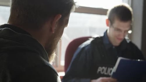 Man Giving Statement to Police Officer