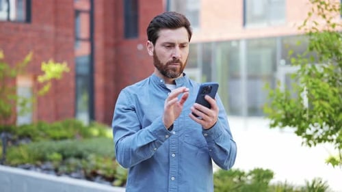 Man Receives Good News on Phone Outside Office