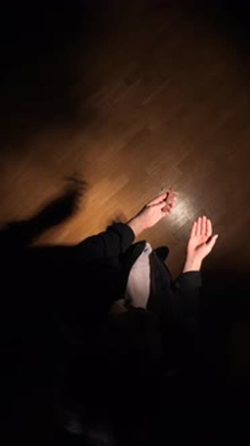 Woman Holding Rosary and Praying with Hands Raised