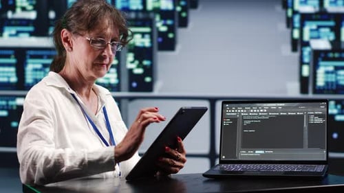 Woman Working on Tablet in a Server Room