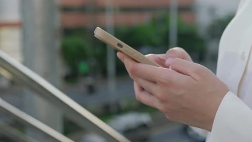 Close View of the Woman Hands Texting Holding Smartphone Browsing in Internet