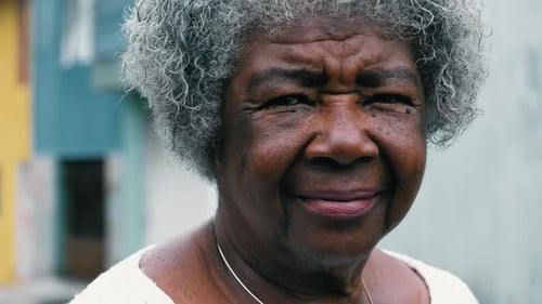 Smiling Senior Woman Looking at Camera in City