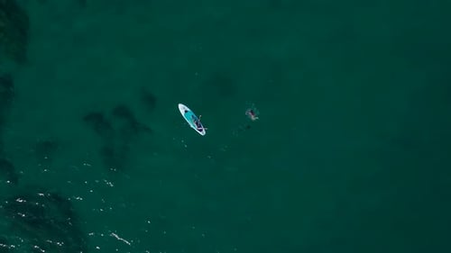 Aerial View Paddleboarding and Enjoying the Open Sea on the First Day of Summer
