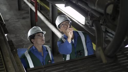 Transit Workers Inspecting Light Rail in Maintenance Facility Adult