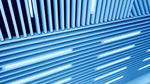 Bright illumination on the embossed plank ceiling. White light led lamps switched on. Low angle view