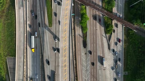 Top down aerial of traffic driving on interstate highways. Commuter vehicle drivers.