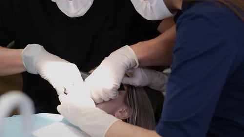 Dentist and Assistant Performing Dental Procedure