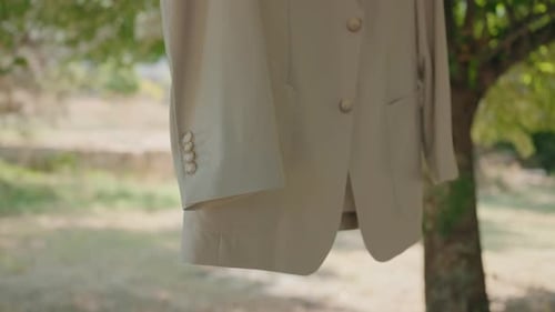 Elegant tan jacket hanging outside in natural light