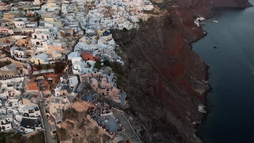 Santorini Greece. Flying Above White Buildings on Top of Red Cliffs, Scenic Oia Village, Drone Shot