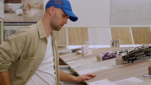 Man Looks at Flooring Samples