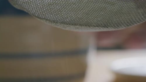 Flour Being Sifted through Mesh Sieve during Baking