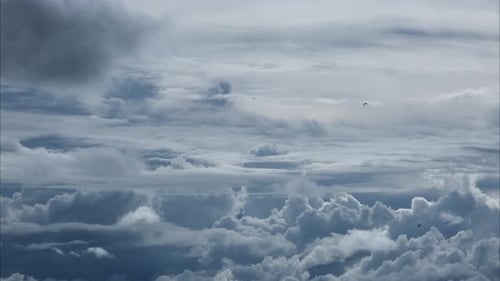 Aerial view of beautiful sky with clouds and sun on a summer day.