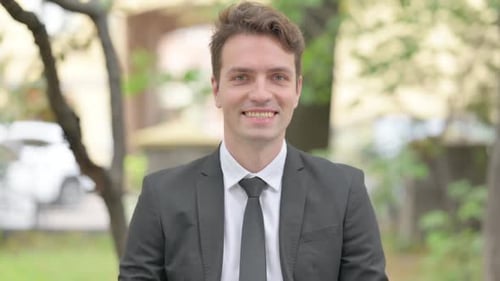 Smiling Young Adult Businessman in a Suit