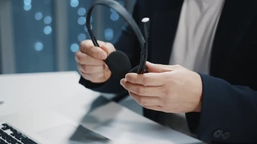 Young Man Putting on Headset in Office