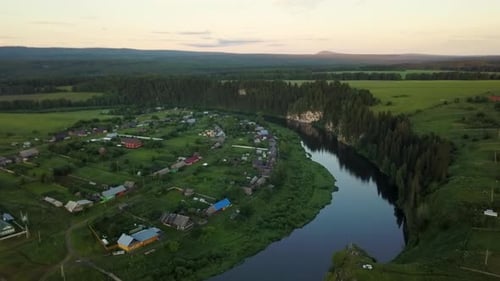 An Aerial View of a Picturesque Rural Village Gracefully Nestled By a Beautiful River Stock Clip