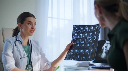 Doctor Explains Scan Results to Patient in Office