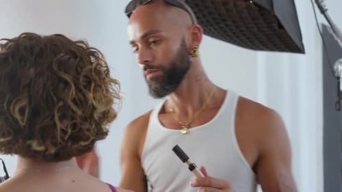 Makeup Artist Applying Makeup to Woman in Studio