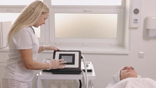 Medical Professional Adjusting a Treatment Device