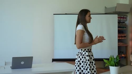 Teacher Explains Lesson in Classroom Setting