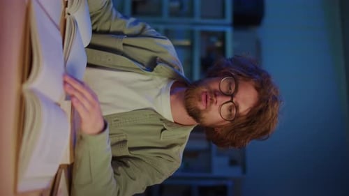 Student Flipping Pages While Studying Late at Night Vertical Video