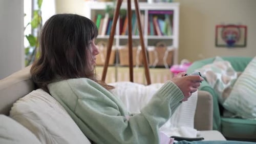Teenager Playing Video Game On Sofa