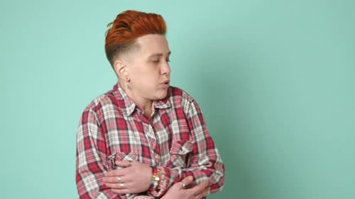 Androgynous Individual in a RedChecked Shirt Feeling the Winter Chill