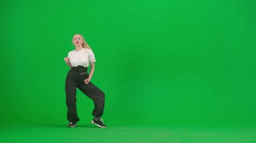 In the Frame on a Green Background Chromakey A Young Slender Beautiful Girl is Dancing She