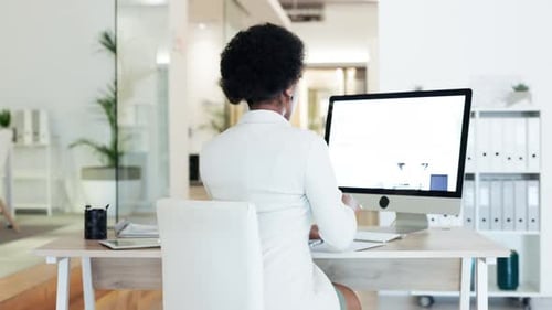 Stressed and tired business woman suffering from fatigue while sitting at a desk in an office