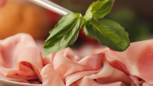 Mortadella Ham Slices Garnished with Fresh Basil