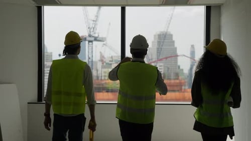 Group of professional civil engineers team working on new building at construction site