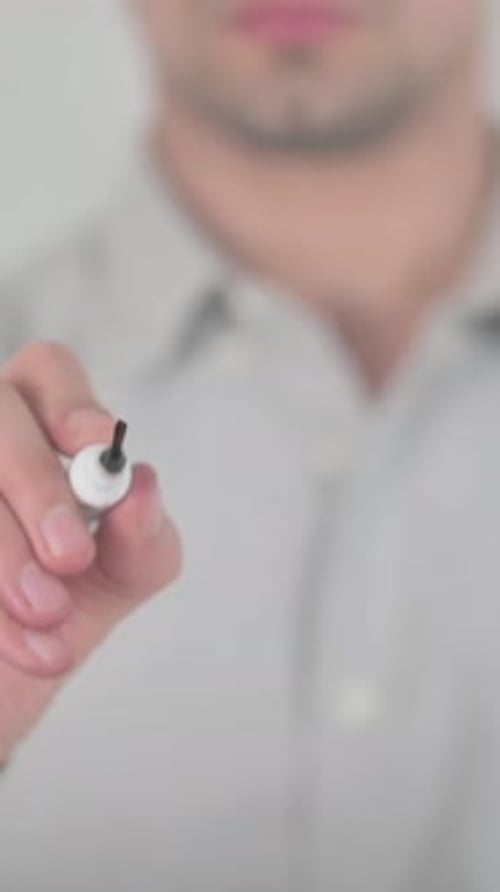 Man Writes Idea on Glass Surface with Marker