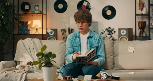 Young Adult Reads British English Dictionary on Couch
